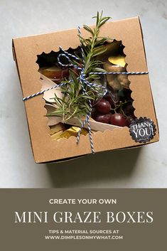 an open box filled with fruit on top of a white counter next to a sign that says create your own mini graze boxes