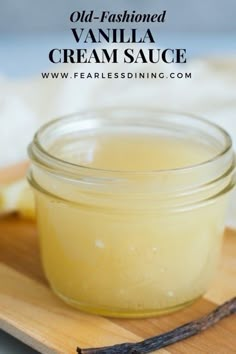 homemade vanilla cream sauce in a glass jar on a cutting board