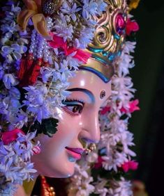 a close up of a statue with flowers on it's head