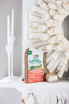 a wreath and some books on a mantle