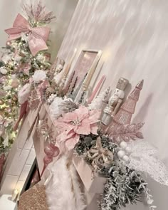 a decorated christmas tree in the corner of a room with pink and white decorations on it