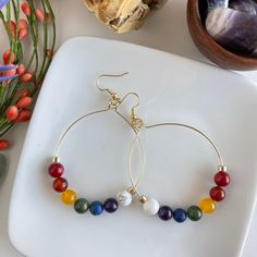 7 Chakra hoop earrings, large hoop earrings, LGBTQ, Rainbow earrings, Gemstone hoop earrings, boho earrings, boho style  These large hoop earrings are handmade with genuine stones (bamboo coral, Carnelian, yellow agate, aventurine, lapis lazuli, amethyst, white howlite) on gold color wire and his posted beads on 18K gold plated earring wires. * * * The last photo shows an example of the approximate size of the hoop earrings on me. These large hoops measure approximately 1 3/4 inches wide (diamet Lgbtq Rainbow, Hoop Earrings Large, Wire Hoop Earrings, Yellow Agate, Mala Bead Necklace, Gemstone Hoop Earrings, Bamboo Coral, Vintage Style Earrings, Earring Wires