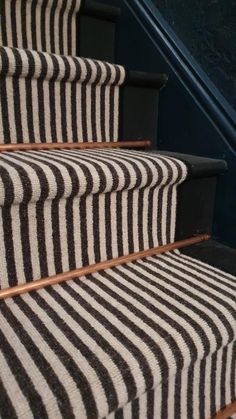 striped carpeted stairs with black and white stripes