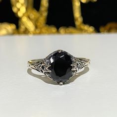 a black diamond ring sitting on top of a table