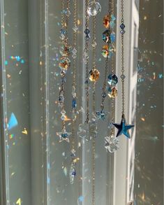 a wind chime hanging from the side of a window with lots of stars on it