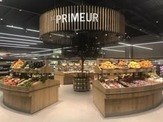 the produce section of a grocery store with fruits and vegetables on display in wooden baskets