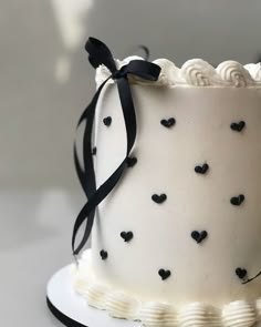 a white cake with black hearts on it