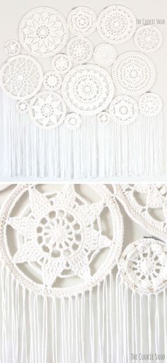 white crocheted doily with tassels hanging from the side on a wall