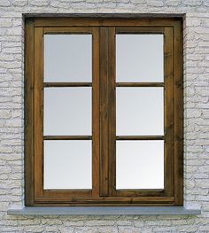 an open window on the side of a white brick building with wood trim and panes