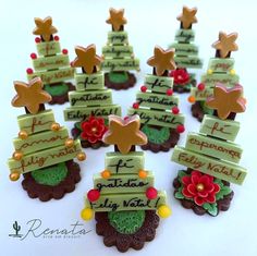 there are many small christmas trees made out of cookies and candy canes with writing on them