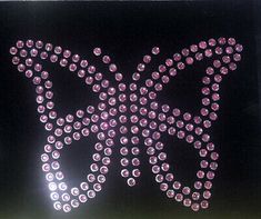 a large butterfly made out of pink and white diamonds on a black background with the word'butterflies'written across it