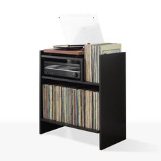 an old record player is sitting on top of a shelf filled with records and cds