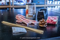 an assortment of items that are sitting on a table next to a can and some chopsticks