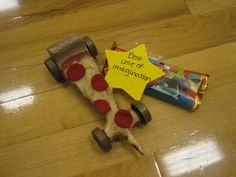 a piece of pizza that has been placed on the floor next to a candy bar