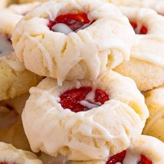 strawberry shortcakes with white frosting and jelly on top are piled up in a pile