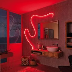 a bathroom with red lighting and a mirror on the wall that says tiras de colors diy