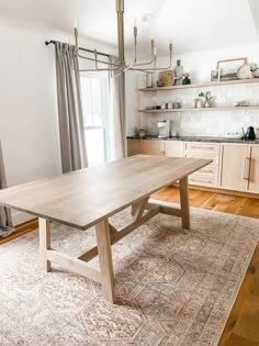 a large wooden table sitting on top of a rug