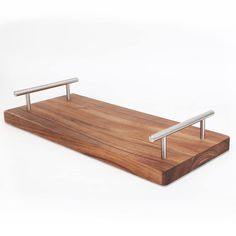 a wooden tray with two metal handles on it