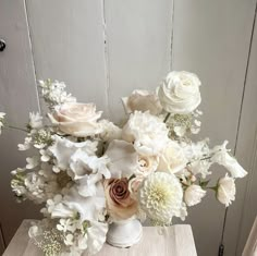 a vase filled with lots of white flowers