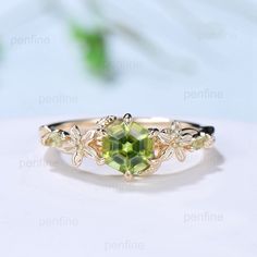 an image of a ring with green stones on the front and yellow diamonds on the back