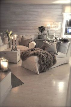 a living room filled with furniture and candles