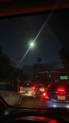 cars stopped at a traffic light in the dark