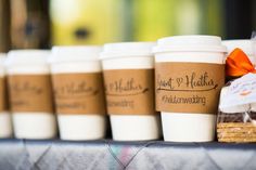 coffee cups are lined up on a table