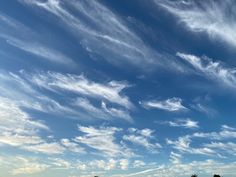 the sky is filled with white clouds and blue skies