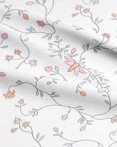 a white and pink floral print fabric with small flowers on the bottom half of it