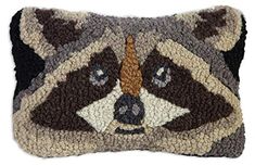 a pillow with a raccoon face on it