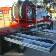 a flatbed tow truck is loaded with equipment