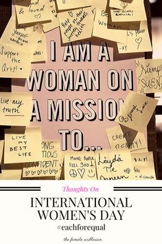 the international women's day poster is posted on a post - it note board