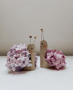 two small figurines made out of toilet paper and flowers