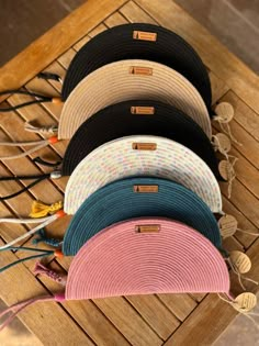 five hats sitting on top of a wooden table