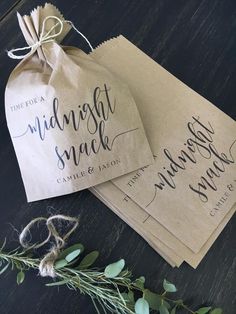 two brown paper bags sitting on top of a wooden table