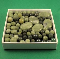 a white container filled with green and black rocks