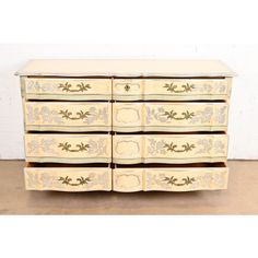 an old dresser with drawers painted yellow and white