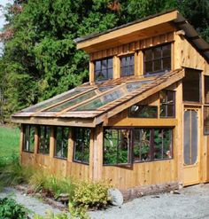 a small wooden building with lots of windows