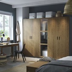 a bedroom with blue walls and wooden furniture