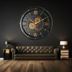 a living room with a couch and a large clock on the wall in front of it