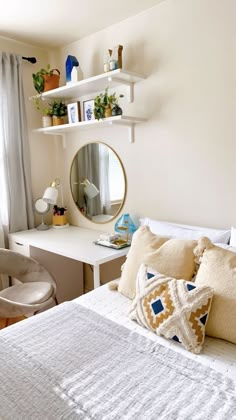 a bedroom with a bed, desk and mirror