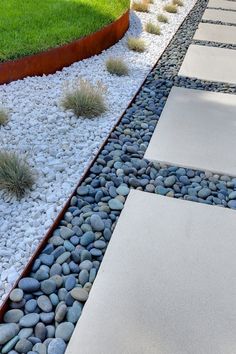 an image of a garden with rocks and gravel on it's side, in the middle