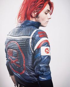 a woman with red hair wearing a blue leather jacket