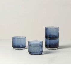 three blue glasses sitting on top of a table