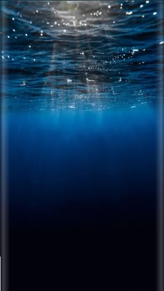 an underwater view of the ocean with blue water