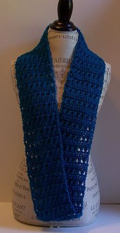 a blue crocheted scarf on top of a mannequin