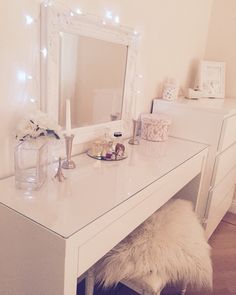 a white desk with a mirror and lights on it