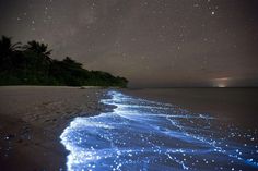 the ocean with stars in the sky above it and a poem written on the sand