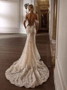 the back of a woman's wedding dress in a hallway