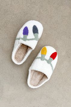 The Holiday Slippers will put a big smile on your face the moment you hop out of bed in the morning! Featuring a holiday light pattern, closed toe, mismatch design, ivory and rainbow colors, mocha interior, soft fabric and rubber soles. Pair these slippers with your favorite festive pajamas! Details & Sizing Christmas light pattern Closed toe Mixmatch design Ivory and rainbow colors Mocha interior Soft fabric Rubber soles Sizing Extra small: 5/6 Small: 7/8 Medium: 9/10 Large: 11/12 Shipping & Re Holiday Slippers, Christmas Slippers, Light Pattern, Christmas Light, Holiday Lights, Rainbow Colors, Christmas Lights, Mocha, Soft Fabric